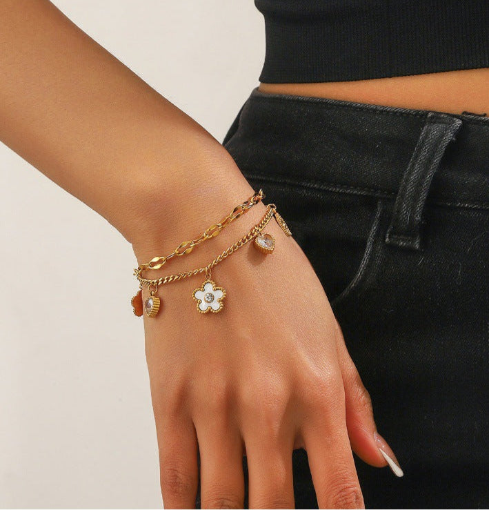 Gold bracelet on a wrist with a close-up of the bracelet on a white background.